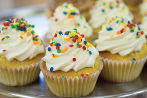 Traditional vanilla cupcakes with vanilla buttercream frosting andivd sprinkles.