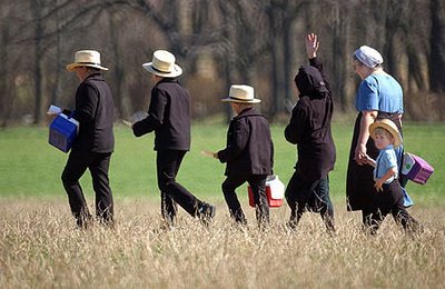 A picture of an Amish father and his children walking.