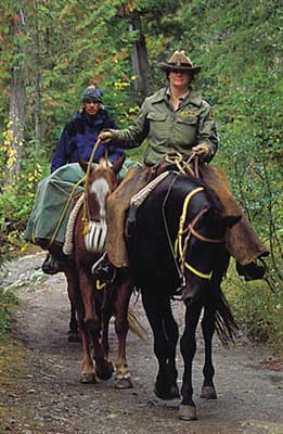 The end of the trail -- Paradise Mountain guide and guests return from a long day's ride exploring the resort wilderness areas.